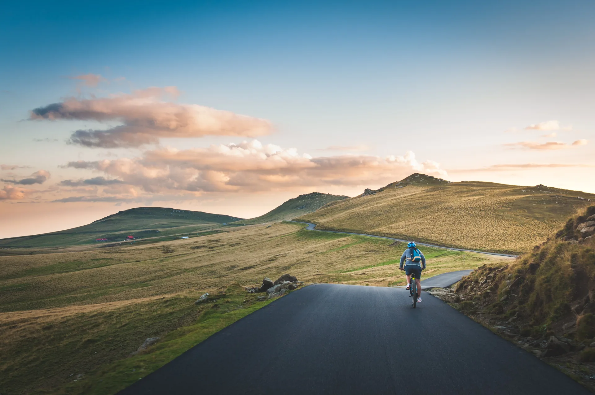 A road cyclist alone on an open upland road at first light