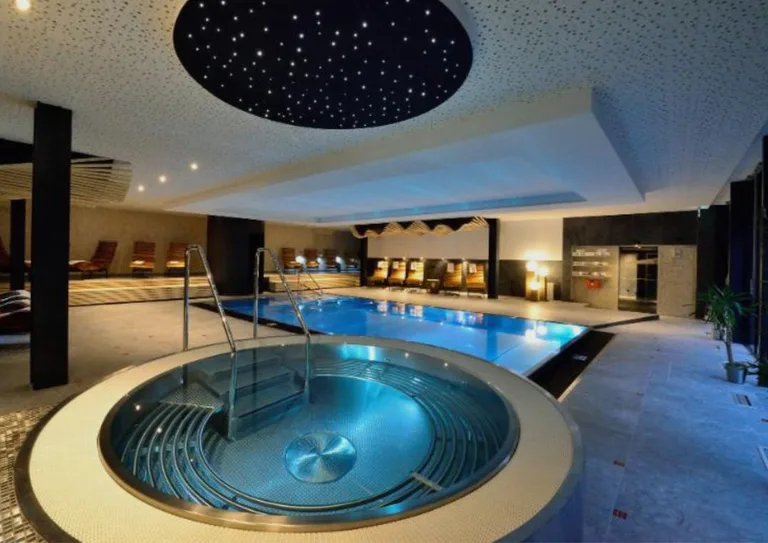 The indoor pool and whirlpool at Montanie Resort, lit beneath a starlit ceiling